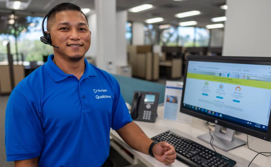 Concierge team member Jen Juico stands at his workstation.